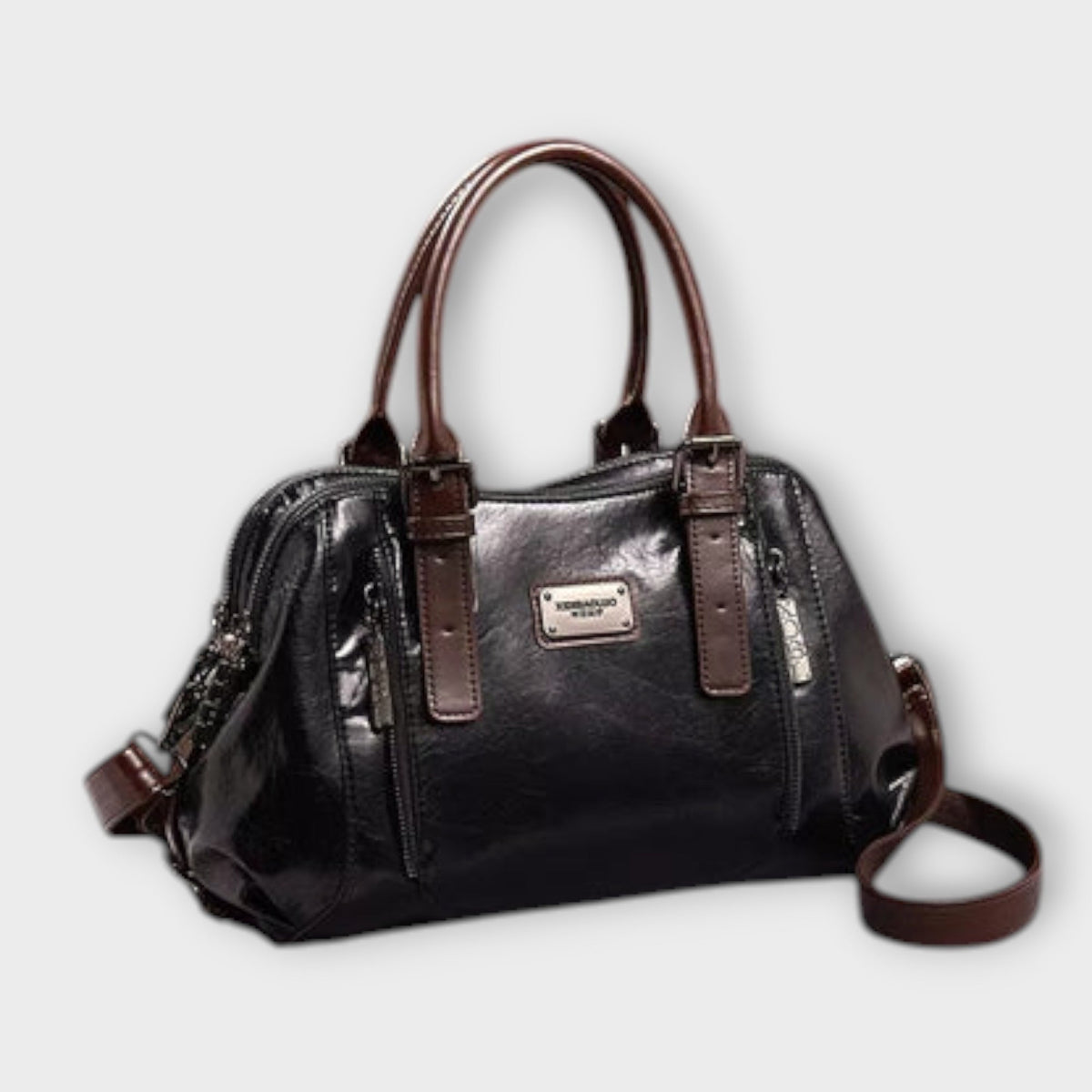 Black leather-look shoulder bag with top handles, front logo plaque, zip top, crossbody strap.