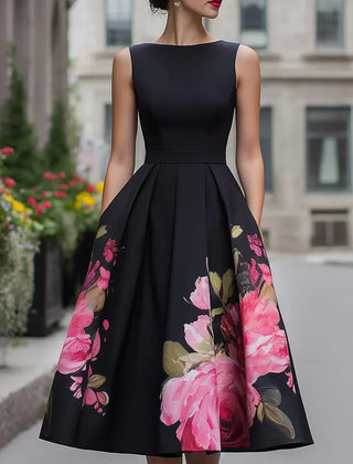 Black sleeveless midi dress with fitted bodice and full skirt, pink floral print panels