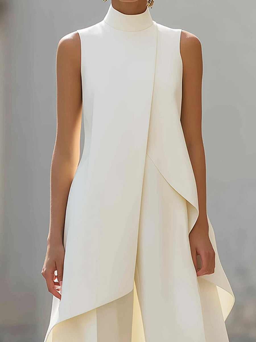 White sleeveless tailored vest top with draped asymmetric layer; matching pants