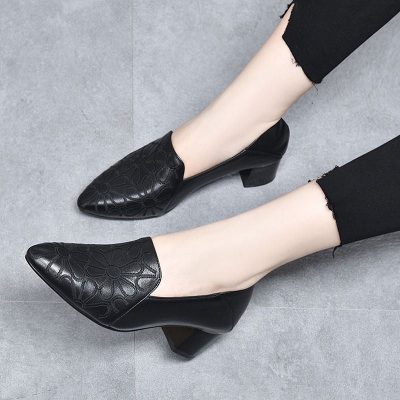 Black embroidered leather pumps with pointed toe and textured floral pattern