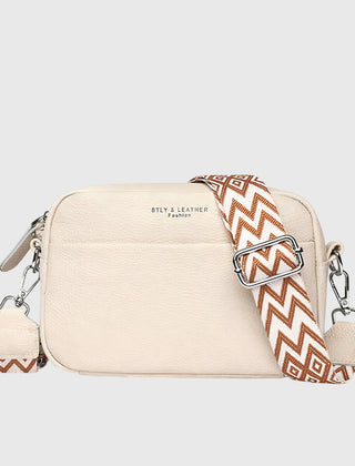 Beige leather shoulder bag with patterned chevron strap and side zipper pulls
