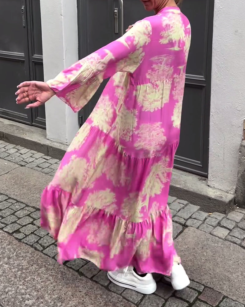 Pink long dress with cream and green abstract pattern, relaxed tiered silhouette, long sleeves.