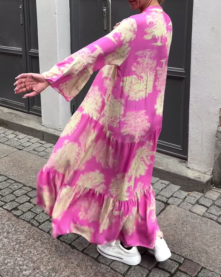 Pink long dress with cream and green abstract pattern, relaxed tiered silhouette, long sleeves.