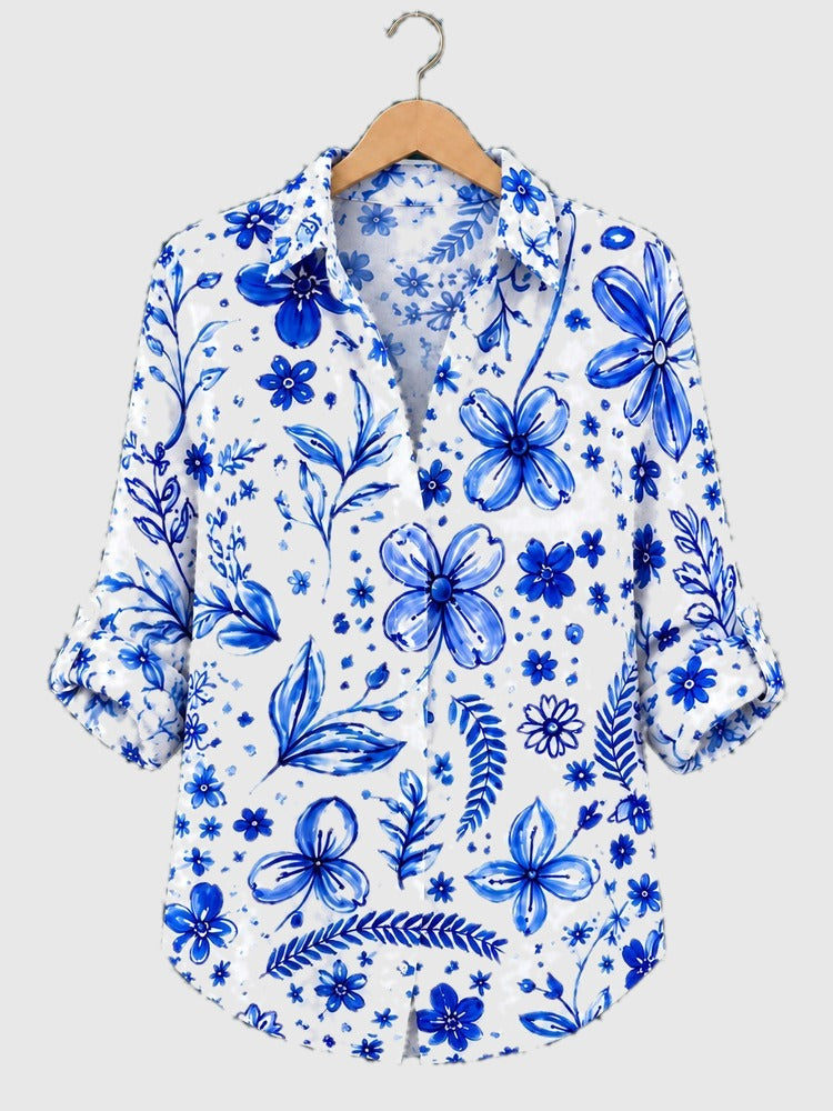 Blue floral button-up shirt with short sleeves and collar, all-over delft print