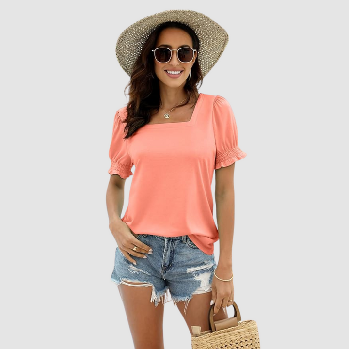 Coral square-neck blouse with short puff sleeves and gathered cuffs.