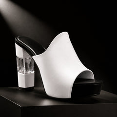 White peep-toe mules with clear block heel and black platform base