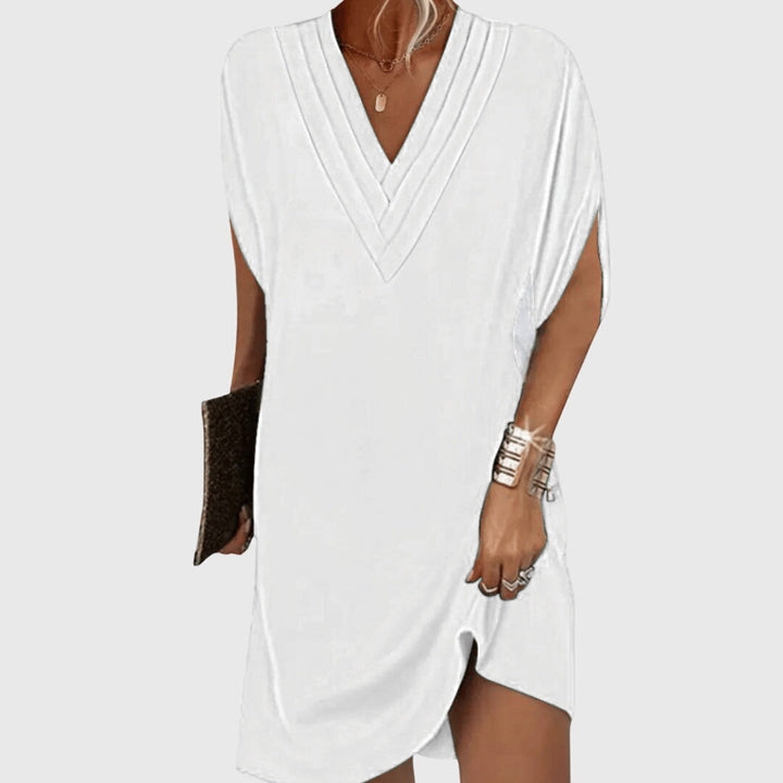 White draped V-neck dress with short sleeves and wrap-like crossover front