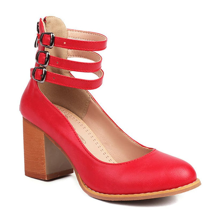 Red triple-buckle strap heels with chunky block heel and curved toe