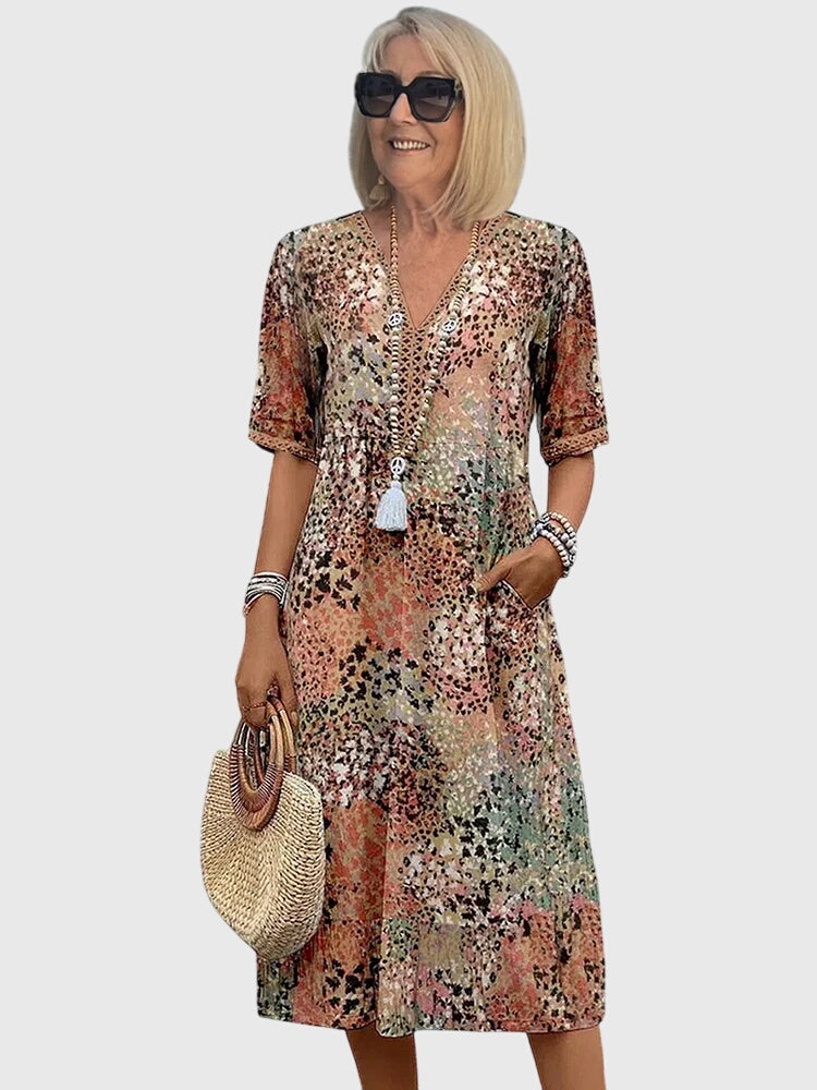 Sandy beige floral midi dress with V-neck, short sleeves, and white tassel detail
