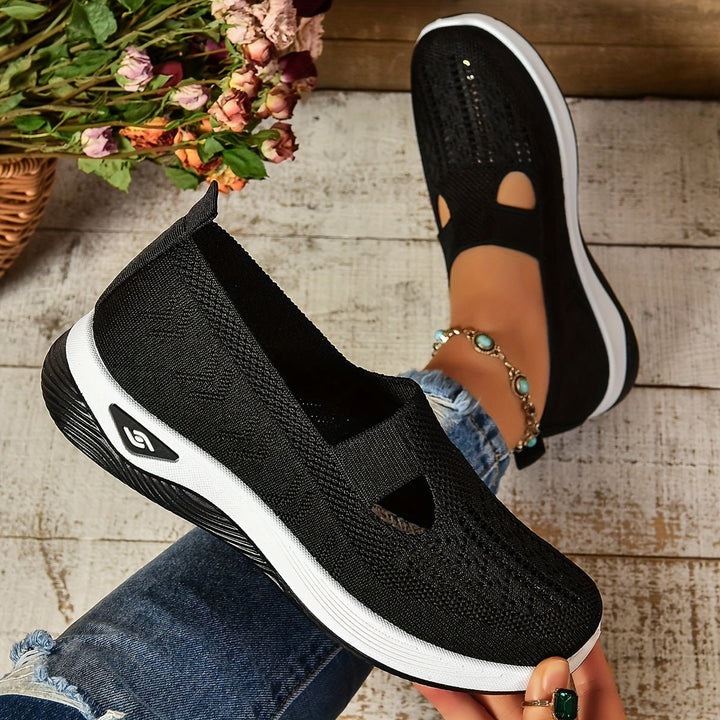 Black knit orthopedic slip-on shoes with oval cutouts and white sole