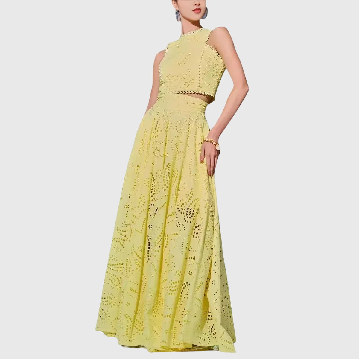 Yellow two-piece set with sleeveless lace crop top and full midi skirt