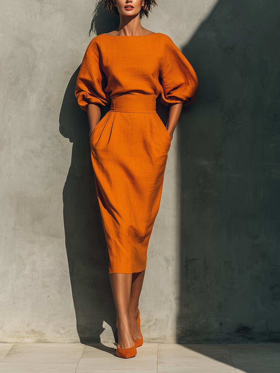 Orange skirt set with puff sleeves, cropped knit top and fitted midi pencil skirt