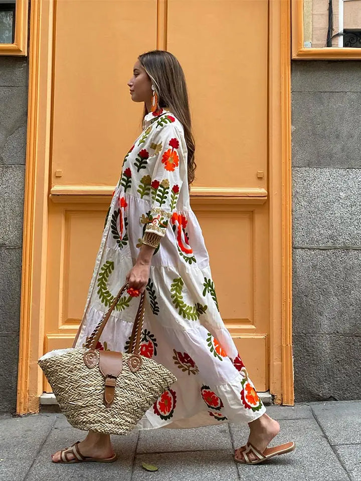 White A-line maxi dress with long sleeves and red green orange folk floral print