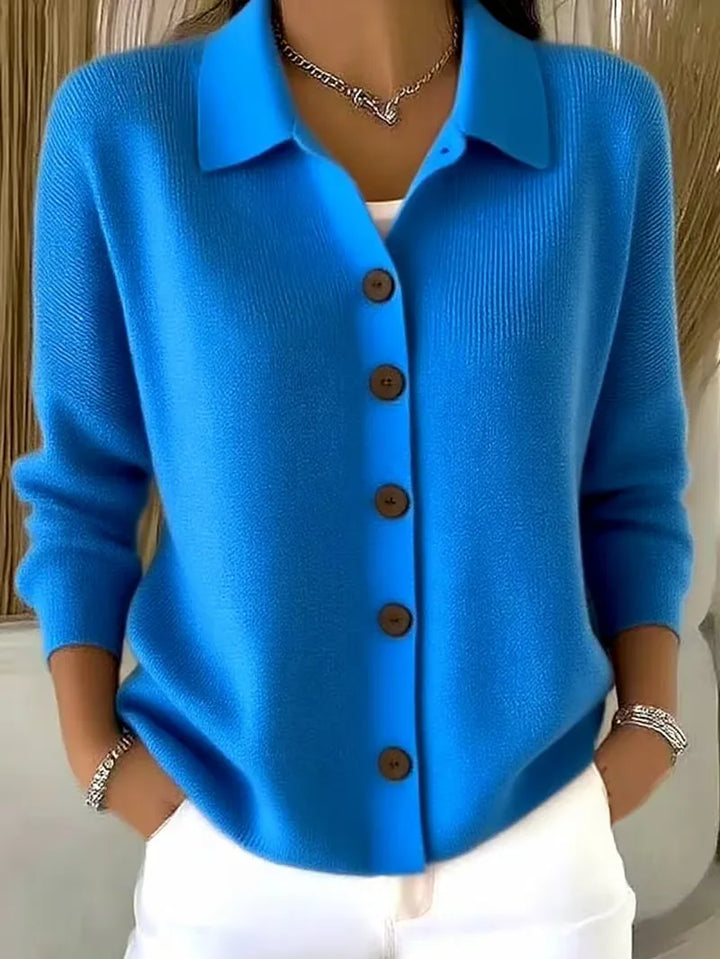 Blue button-front knit cardigan with point collar and dark buttons, long sleeves
