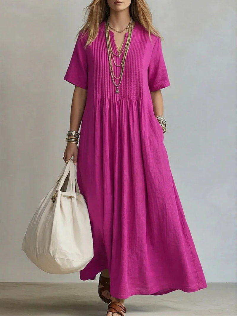 Pink pleated short-sleeve dress with gathered neckline and flowy maxi length