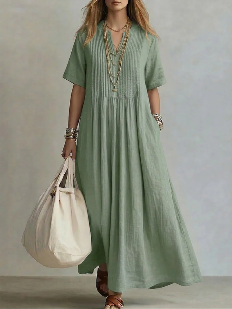 Green pleated short-sleeve dress with gathered neckline and flowy maxi length