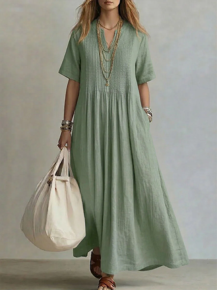 Green pleated short-sleeve dress with gathered neckline and flowy maxi length