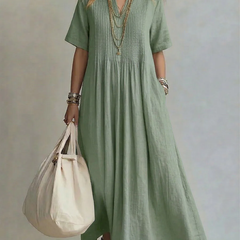 Green pleated maxi dress with short sleeves and round neckline