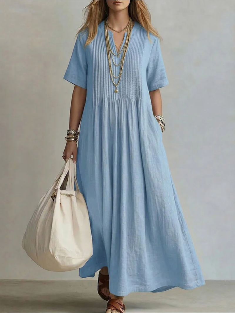 Light blue pleated short-sleeve dress with gathered neckline and flowy maxi length