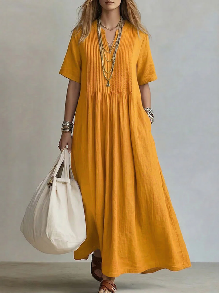 Yellow pleated short-sleeve dress with gathered neckline and flowy maxi length