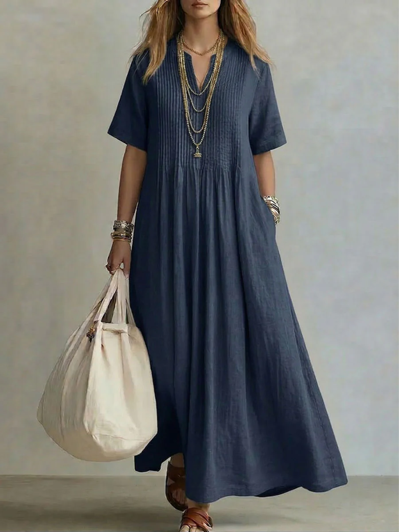 Navy pleated short-sleeve dress with gathered neckline and flowy maxi length