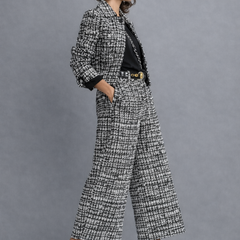 Black-and-white tweed blazer and wide-leg pants set, side view with belt detail