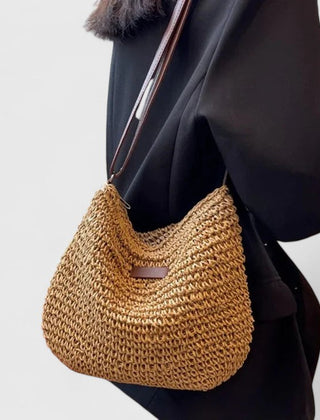 Khaki woven half-moon bag with brown leather strap and front logo patch