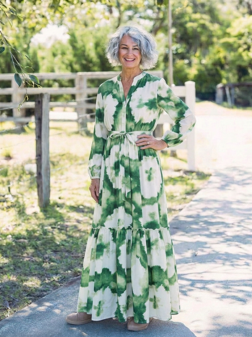 Long sleeve tiered maxi dress with green and white floral print and tie belt detail