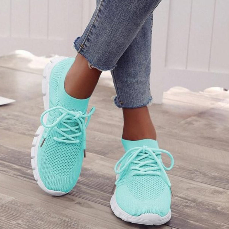 Light green performance running sneakers with lace-up mesh upper and white sole