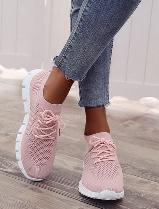 Pink performance running sneakers with lace-up mesh upper and white sole