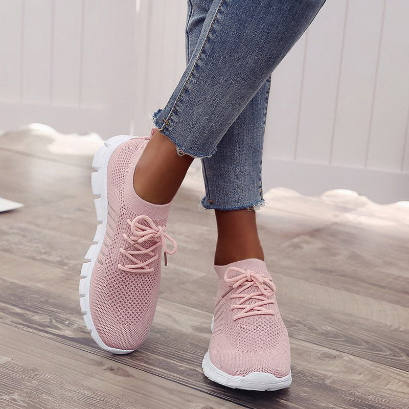 Pink performance running sneakers with lace-up mesh upper and white sole