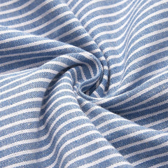 Blue-and-white striped fabric closeup with soft drape texture