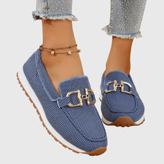 Blue orthopedic loafer sneakers with gold buckle ornament and rubber tread sole