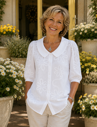 White floral embroidered blouse with round collar and short puff sleeves