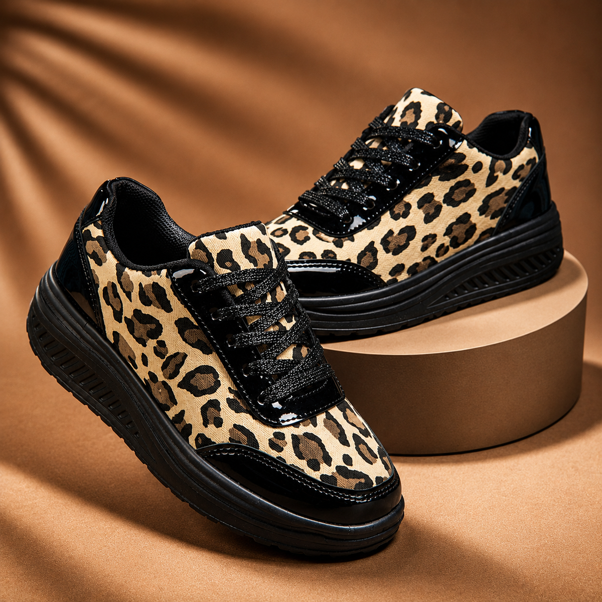Leopard print platform sneakers with black lace-up, black panels, ridged sole