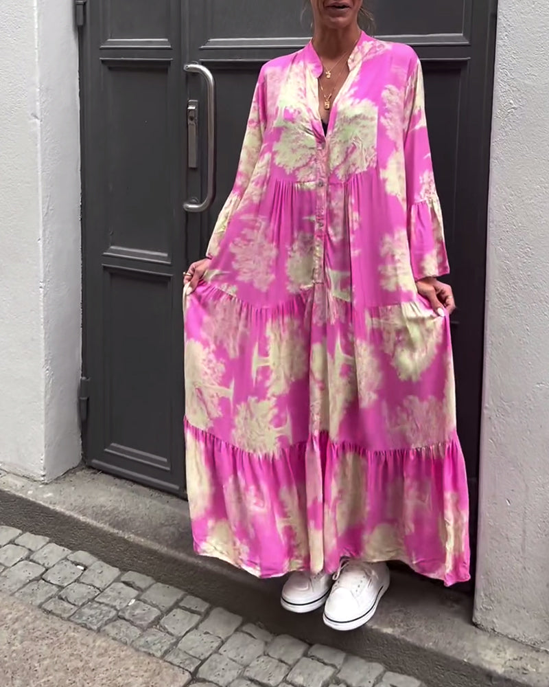 Pink maxi dress with multicolor abstract tie-dye print, button-front V neckline, tiered hem.