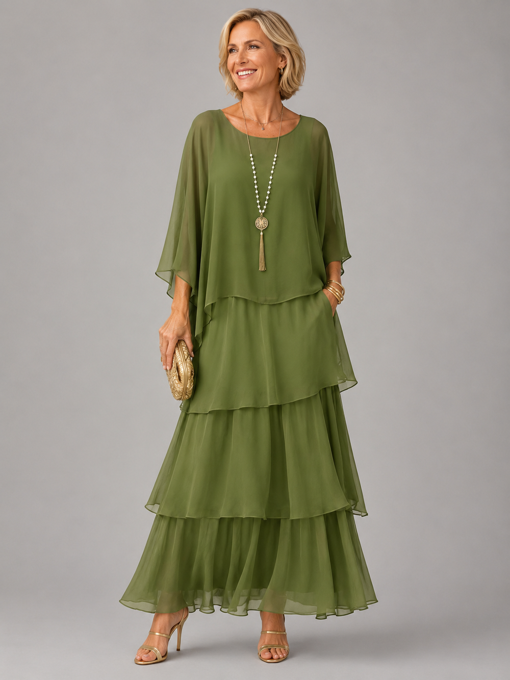 Green tiered maxi dress with draped cape sleeves and flowing ruffle layers