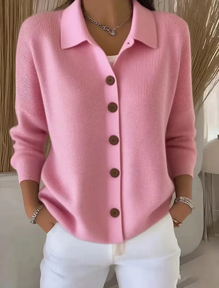 Light pink button-front knit cardigan with point collar and dark buttons, long sleeves