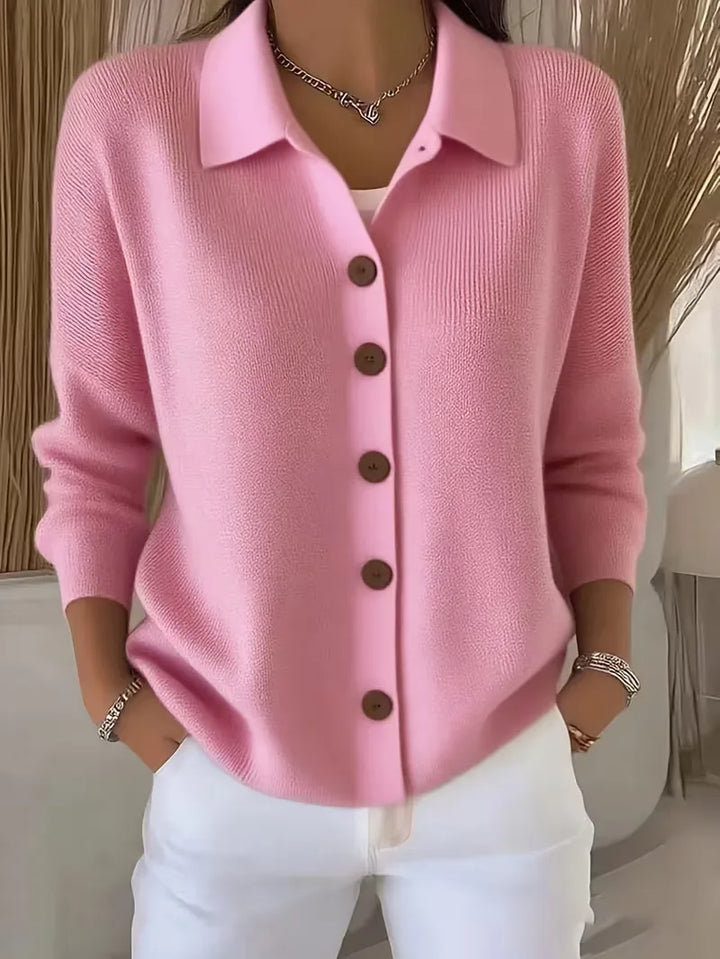 Light pink button-front knit cardigan with point collar and dark buttons, long sleeves