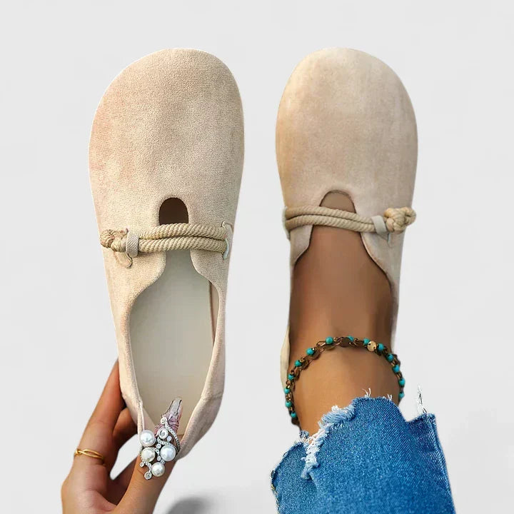 Beige orthopedic loafer slip-on with braided bow strap across the vamp