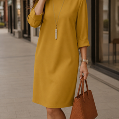Mustard yellow midi dress with round neckline and 3/4 sleeves, relaxed fit