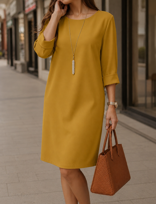 Mustard yellow midi dress with round neckline and 3/4 sleeves, relaxed fit