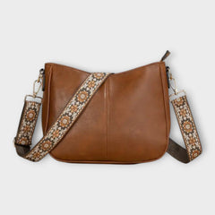 Brown vegan crossbody bag with patterned strap and chain shoulder straps