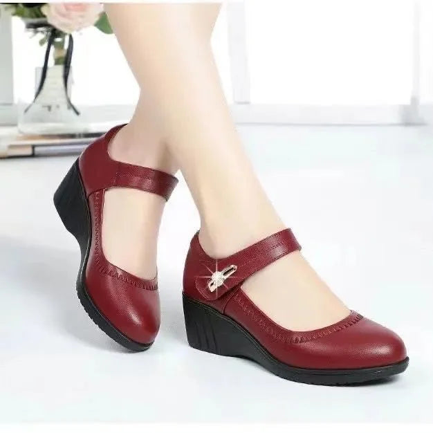 Red mid-heel Mary Jane shoes with T-strap and decorative buckle at instep