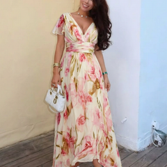 Pink floral V-neck maxi dress with short sleeves, gathered waist, and asymmetrical hem