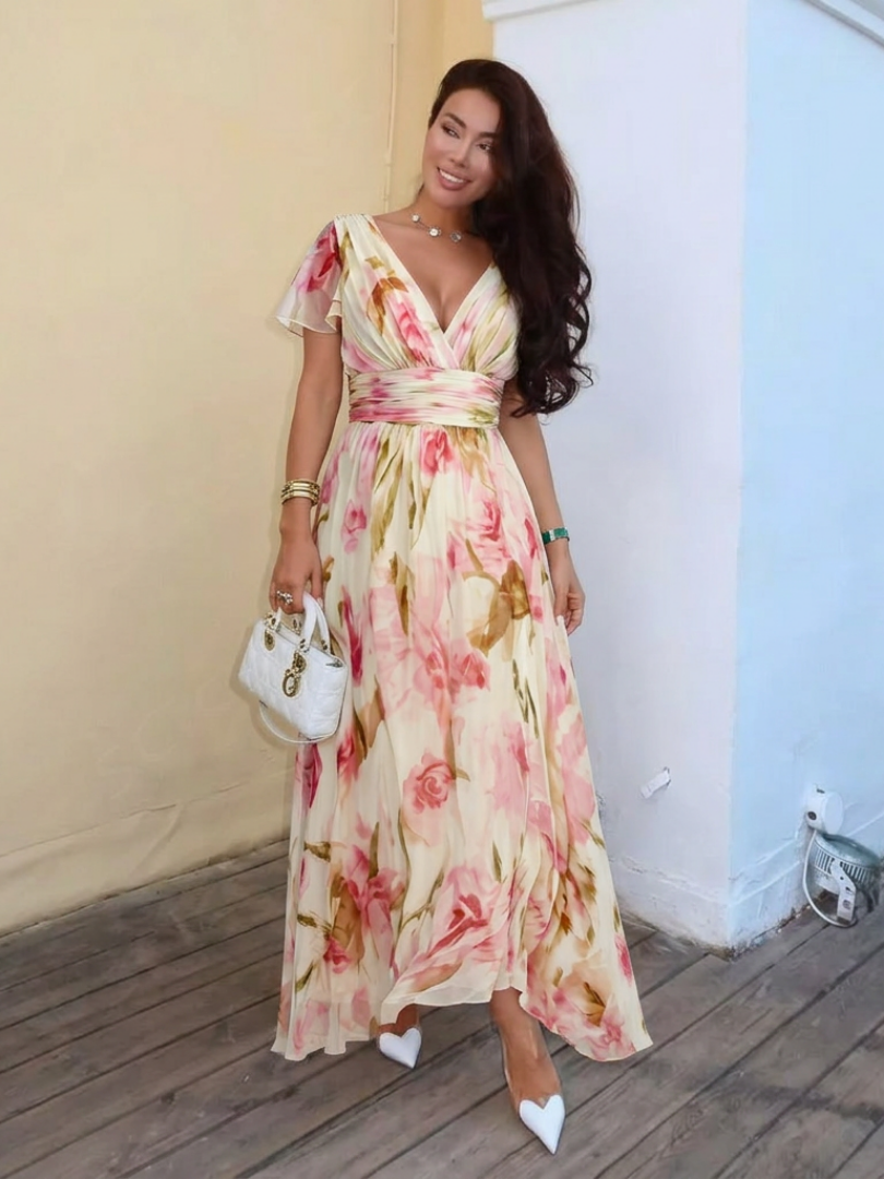 Pink floral V-neck maxi dress with short sleeves, gathered waist, and asymmetrical hem