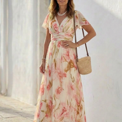 Pink floral V-neck maxi dress with wrap bodice, elastic waist, and soft chiffon-like drape