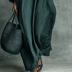 Teal long-sleeve maxi dress with floral embroidery front and draped skirt