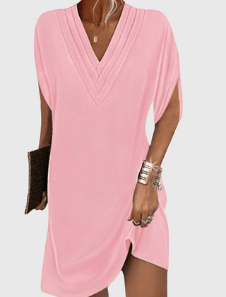 Pink draped V-neck dress with short sleeves and wrap-like crossover front