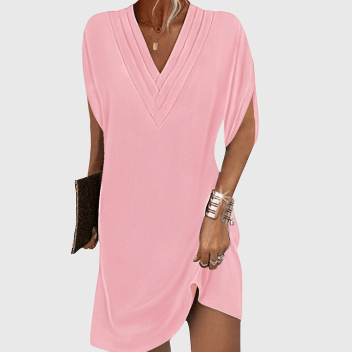 Pink draped V-neck dress with short sleeves and wrap-like crossover front